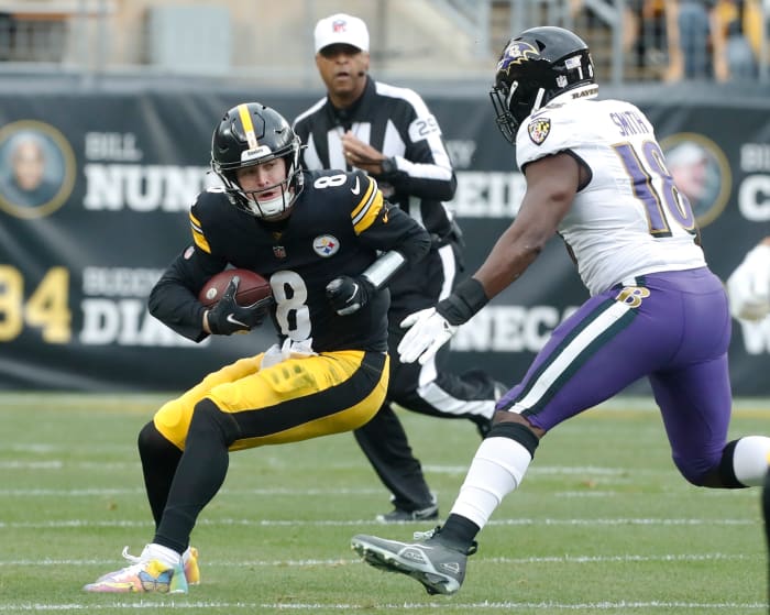 Pittsburgh Steelers quarterback Kenny Pickett (8) is sacked by Baltimore Ravens linebacker Roquan Smith (18) during the first quarter at Acrisure Stadium.
